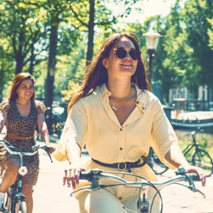 Contiki travellers cycle along Amsterdam's tree-lined canals on the European Whirl Tour