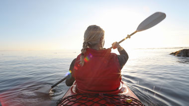 Traveller kayaking on the sea