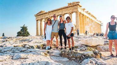 Travellers in front of the Acropolis in Athens, Greece