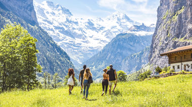 Travellers hiking through the valley of Lauterbrunnen, Switzerland