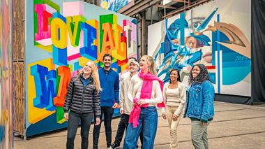 Travellers enjoying the Straat Museum artwork in Amsterdam, Netherlands