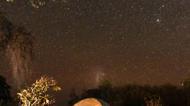 A tent underneath the starry night sky in Okavango Delta, South Africa