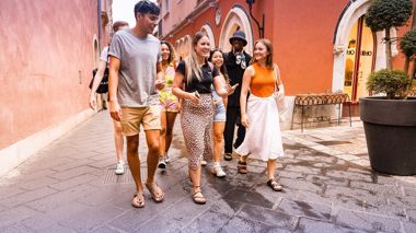 Trip Manager taking travellers down a local street whilst touring Pamplona