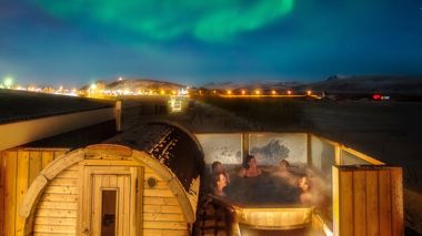 Travellers in the hot tub at Midgard Base Camp in Iceland