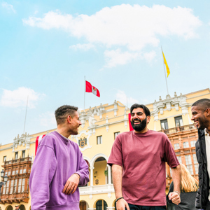 Three travellers chatting standing in Plaza Mayor de Lima, Peru
