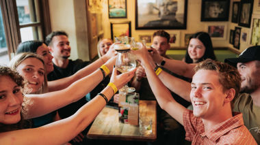 Travellers toasting in a pub, Queenstown, New Zealand