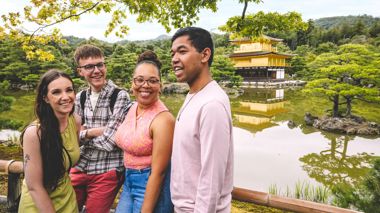 Group of Travellers Smiling in Front of Kinkaku-Ji, Kyoto, Japan