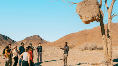 Travellers standing in Etosha National Park with a guide