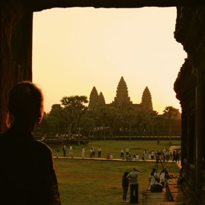 Traveller watches sunrise over Angkor Wat in Siem Reap, Cambodia, on the Contiki Cambodia & Laos Uncovered Tour, discovering one of Southeast Asia's most iconic ancient temples