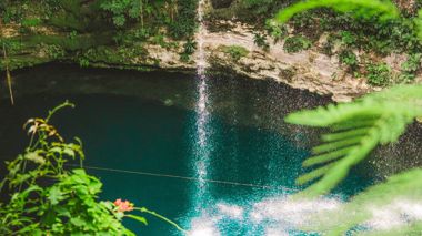 Four Travellers Swimming in Cenote Taken from View Point, Chichen Itza, Mexico
