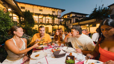 Travellers sampling local food in a restaurant, Tirana, Albania