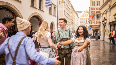 Travellers outside a beer hall, wearing their dirndls in Munich Germany