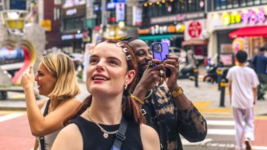 Travellers Looking and Photographing Street in Seoul, South Korea