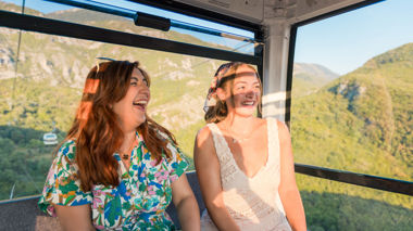 Two travellers riding the cable car up Dajti Mountain, Tirana, Albania