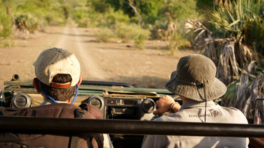 Trainees sat in the front of a safari vehicle, Kruger National Park, Africa