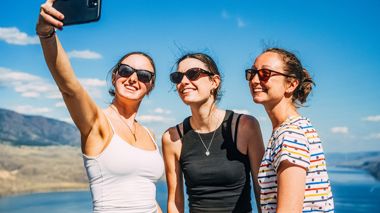 Travellers Taking a Selfie with Lake in Background, Whistler, Canada