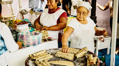 Two women making traditional Oaxacan tacos at a street stall, Mexico City, Mexico