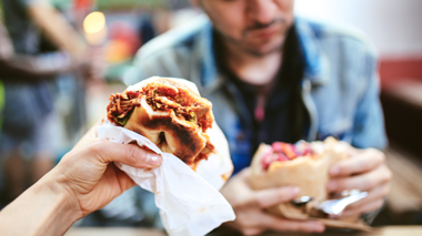 Hand Holding Up Bun/Roll of Food, East End Food Tour, London, UK