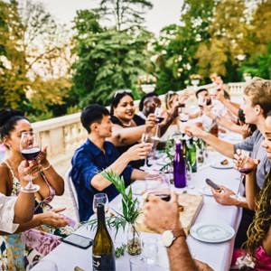 Travellers enjoying food and wine together at a French château on the Contiki Food & Wine in a French Château Tour