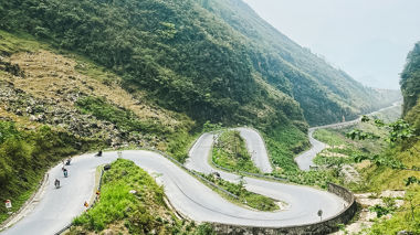 Tight winding road in valley known as Tham Ma Slope, Ha Giang Loop, Vietnam