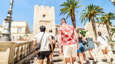 Travellers walking up steps to Korčula, Croatia