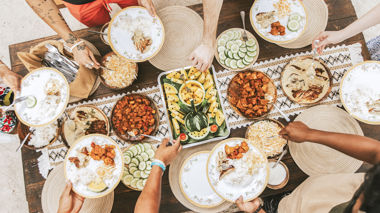 Aerial shot of travellers dishing up local food in Moalboal, Philippines