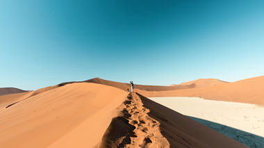 Traveller stood at the Big Daddy sand dune in Sossusvlei, Namibia