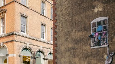 A painting by Banksy on the side of a building in Bristol, United Kingdom