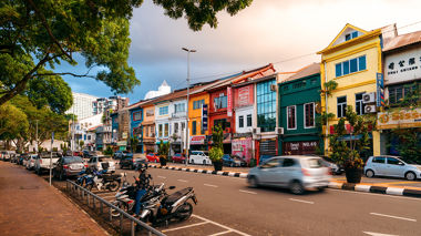 A busy street lined with colourful buildings in Kuching, Borneo, Indonesia