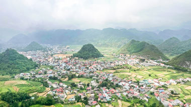 View of town, hills and mountains from Heaven's Gate, Ha Giang Loop, Vietnam