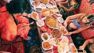 Travellers helping themselves to a spread of Egyptian food, Egypt
