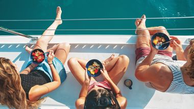 Aerial View of Travellers with Bowls of Fruit on Boat, Great Barrier Reef, Australia