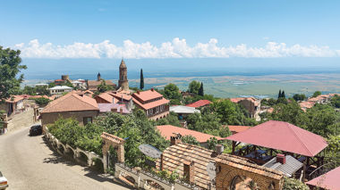Road running through Sighnaghi with a view of the town and valley, Georgia