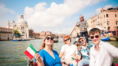 Travellers on a gondola ride in Venice, Italy