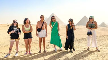 Travellers in front of the Pyramids of Giza in Cairo, Egypt