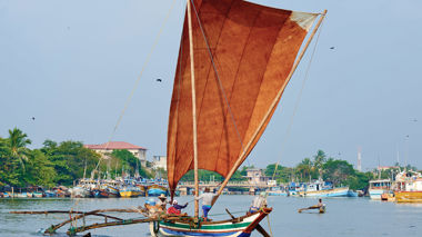 Fisherman sailing on a traditional fishing boat in Negombo, Sri Lanka