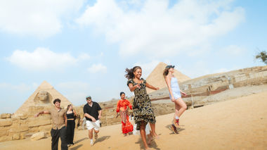 Travellers in front of the Pyramids of Giza in Cairo, Egypt