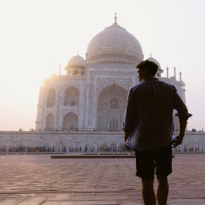Sunrise illuminates the Taj Mahal as a Contiki traveller takes in India's most iconic monument on the Rajasthan & Golden Triangle Tour