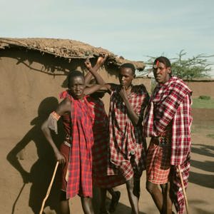 Group meet Maasai community members in a traditional village during Contiki's Kenya: Maasai Mara & Safari Tour
