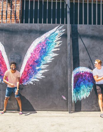 Travellers in front of street art in Los Angeles, USA