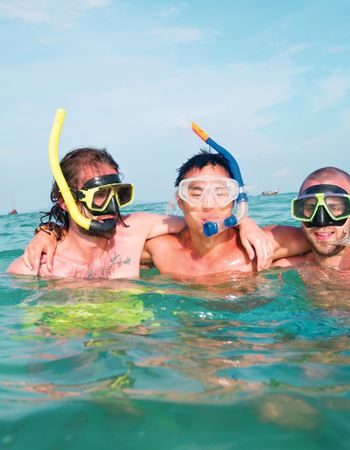 Travellers snorkelling the Great Barrier Reef in Cairns, Australia
