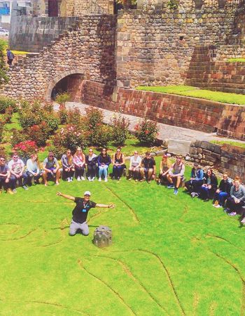 Group of Travellers sat at Coricancha Temple in Cusco, Peru
