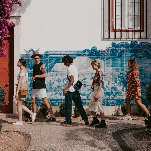 Travellers walking past traditional blue azulejo tiles in Lisbon, Portugal - Contiki Spain, Portugal & Morocco Uncovered Tour