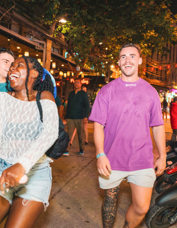 Travellers walking and laughing on Khao San road, Bangkok, Thailand