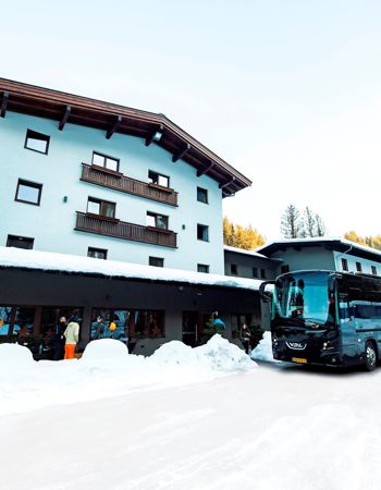 Travellers laughing in the snow in the town of Hopfgarten, Austria