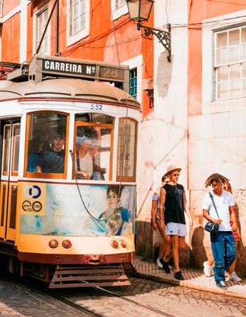 Travellers getting off of a tram in Lisbon, Portugal