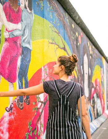 Traveller walking down the East Side Gallery in Berlin, Germany