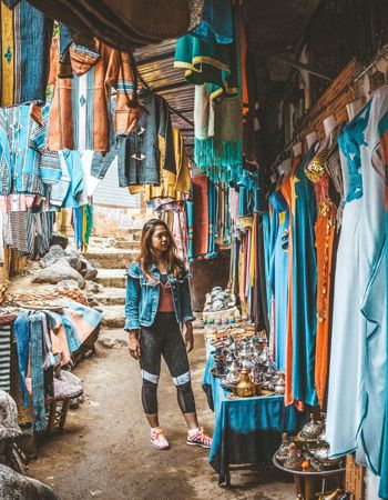 Traveller at a local clothing market in Marrakech, Morocco