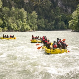 Travellers white water rafting in Austrian Alps
