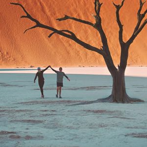 Travellers walking through Deadvlei in Namib-Naukluft National Park, Namibia - Contiki Best of Namibia Tour
